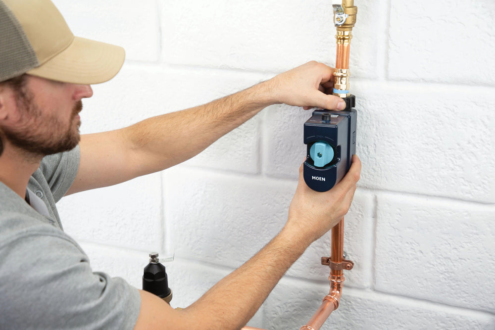 Plumber installing Flo device